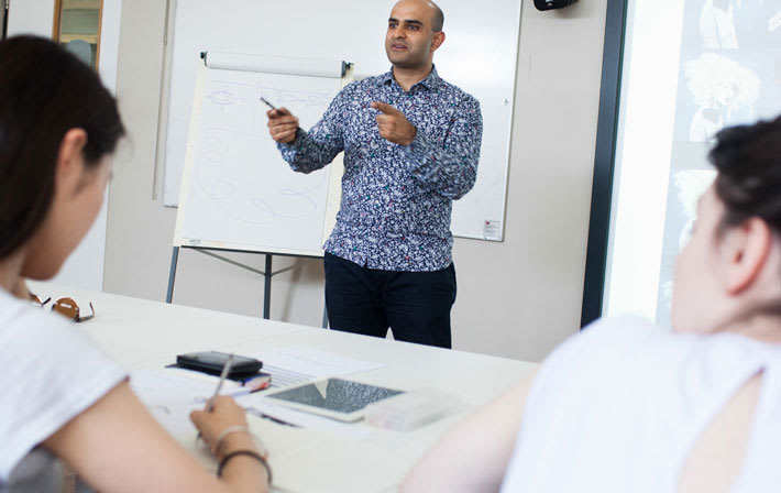 Photo of a man talking in front of a class