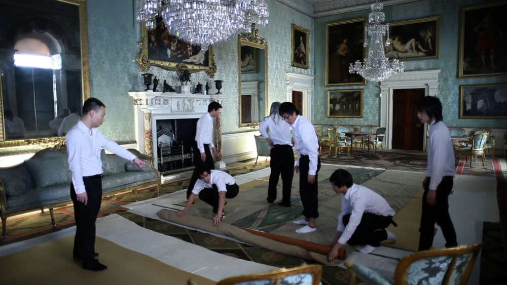Still image of Chinese performers inside a British stately home