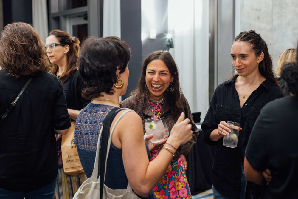 3 women chatting and laughing. 
