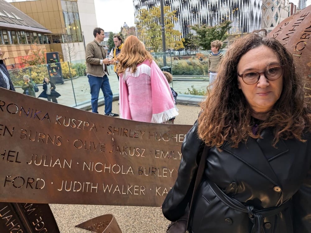 Judith standing next to her name on the 'Ribbons' sculpture