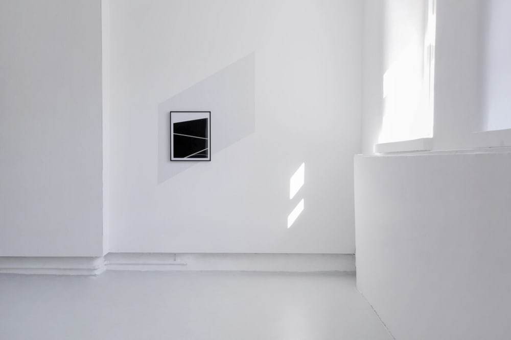 Abstract black and white 2D image hung on wall