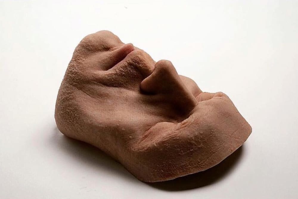 A realistic sculpture of a male face