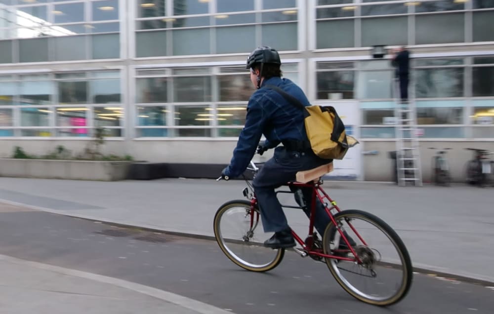 man cycling on road in london