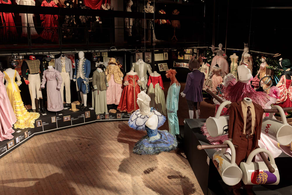 A shot from above a large room with multiple costumes displayed on mannequins.