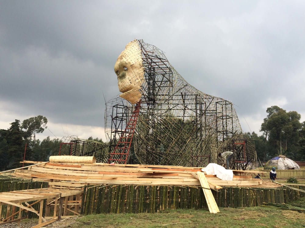 A large model of a gorilla under constraction. The face is woven material. The body is a bamboo and metal frame with struts exposed.