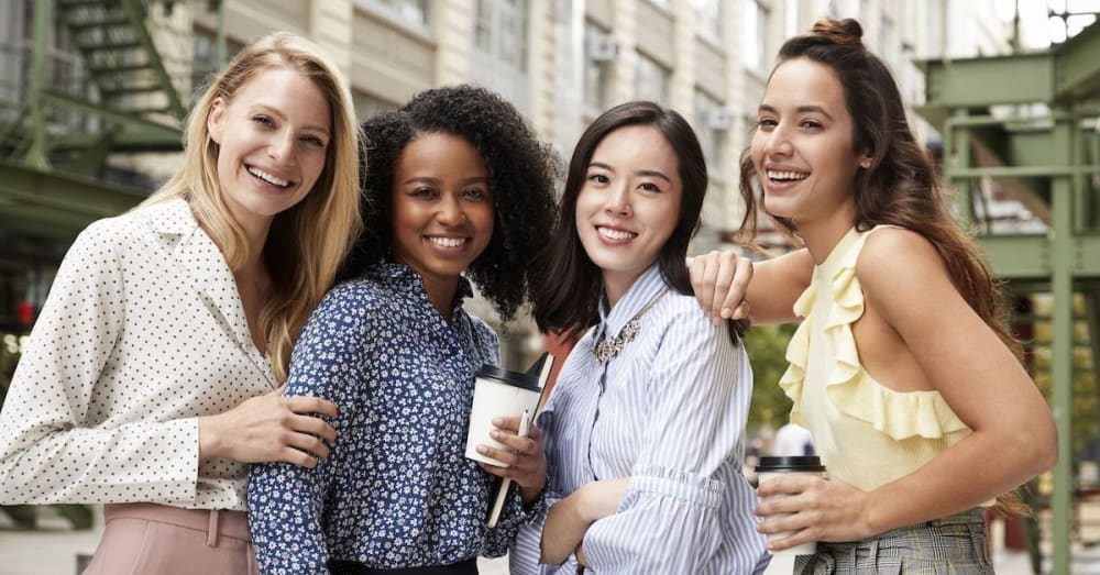 women drinking coffee and smiling together