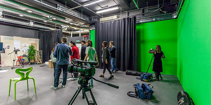 A group of students working with their tutor in the Black Box Project Space.