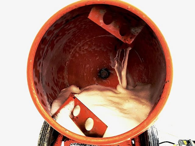 A cement mixer churning a thick white substance