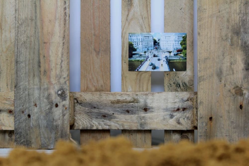 A photograph stuck to a piece of wood