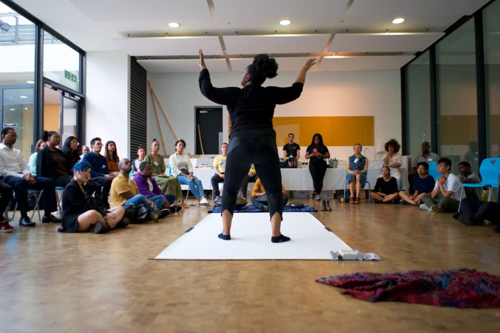 Person performing at UAL Alumni of Colour Association meeting