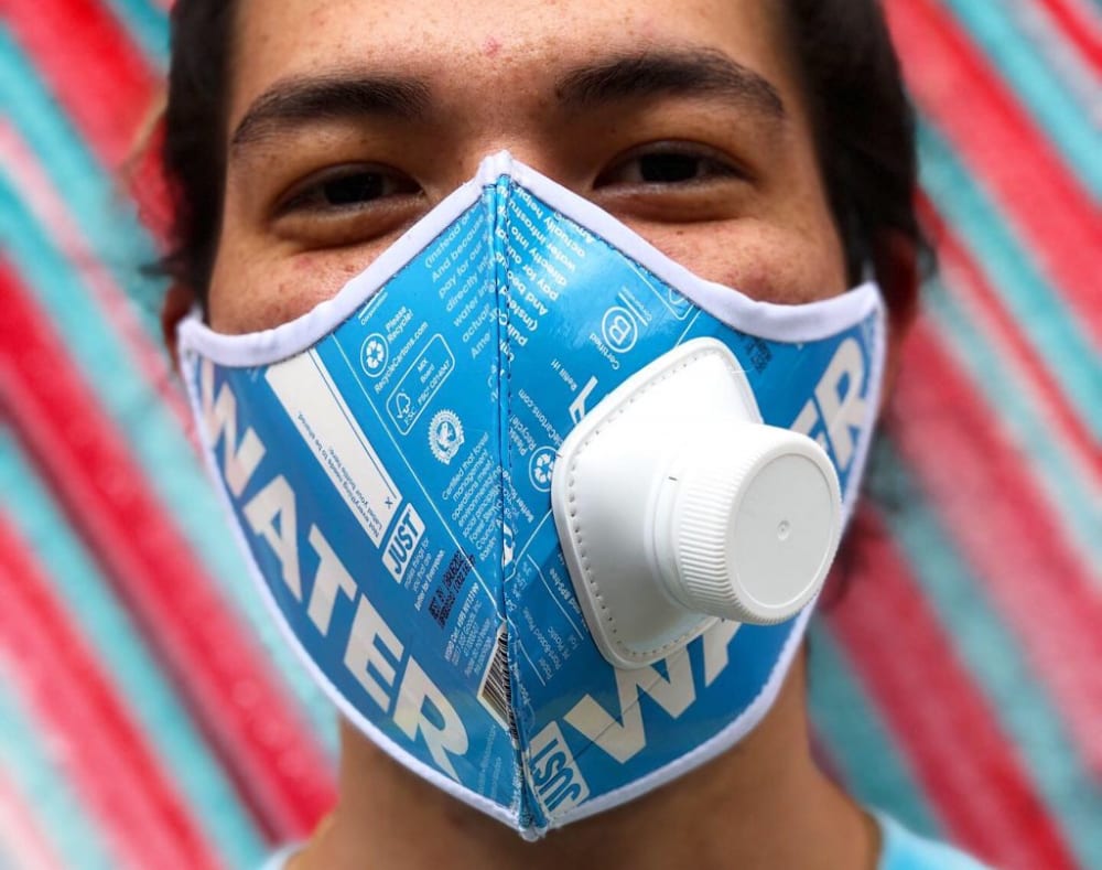a person modelling a face mask made from a water carton