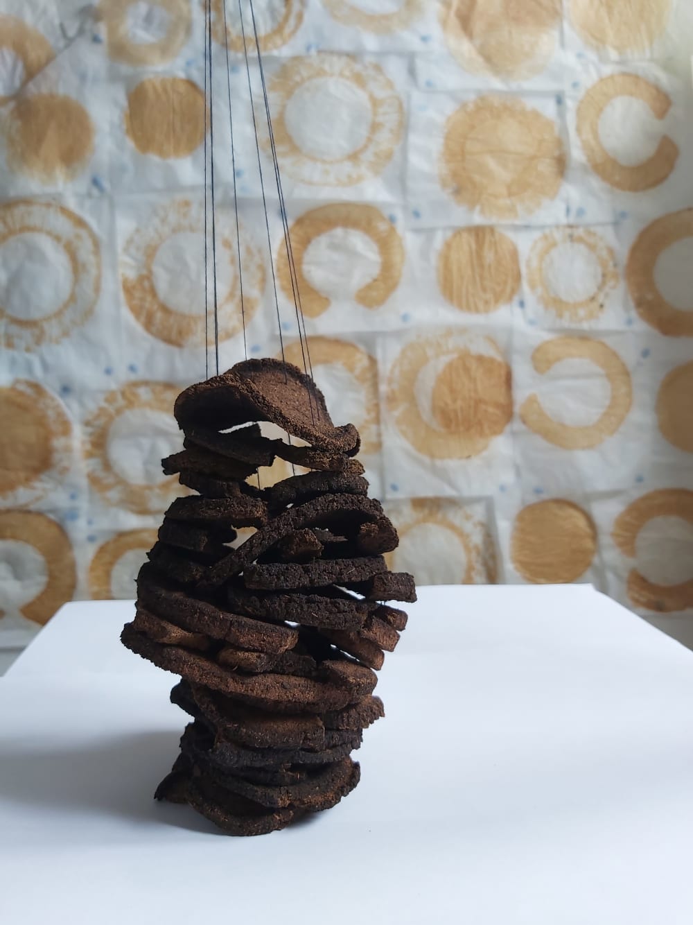 Image of object created from natural materials with process of sustainable footprint in background