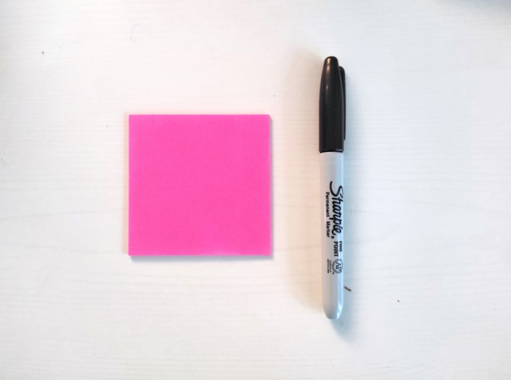 Pink Post-It note with pen