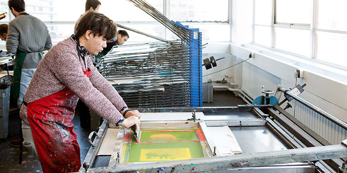 A student in the process of screen printing.
