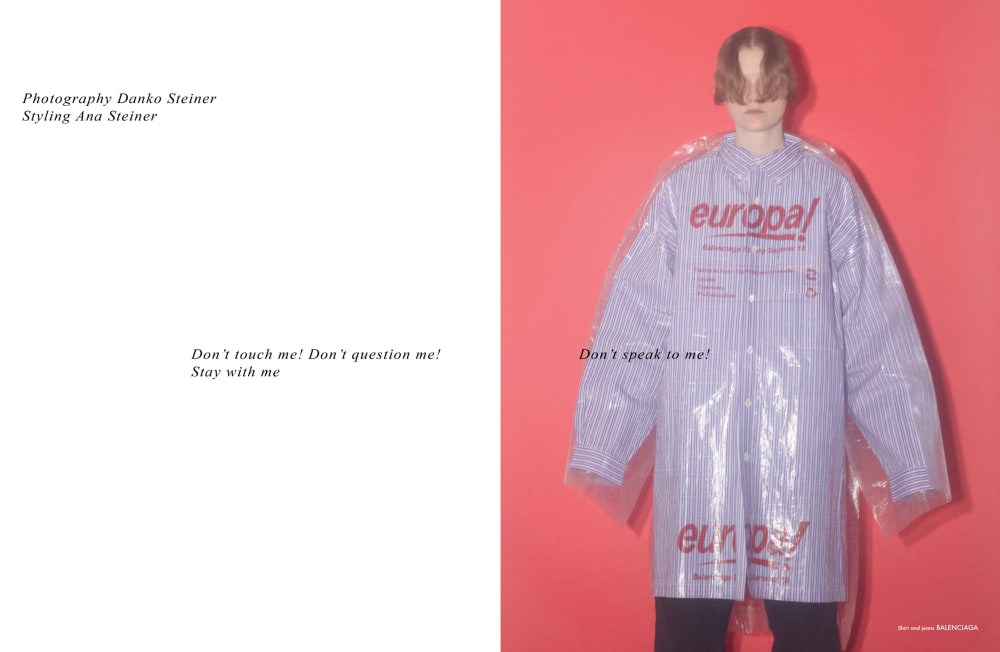 Balenciaga re-edition double page spread Spring/Summer 2018. The left page shows black text on a white background stating: Don't touch me! Don't question me! Stay with me. The right page shows text overlaying a photograph. The text reads: Don't speak to me! The model is dressed in an over-sized striped shirt with a transparent PVC mac layered on top.