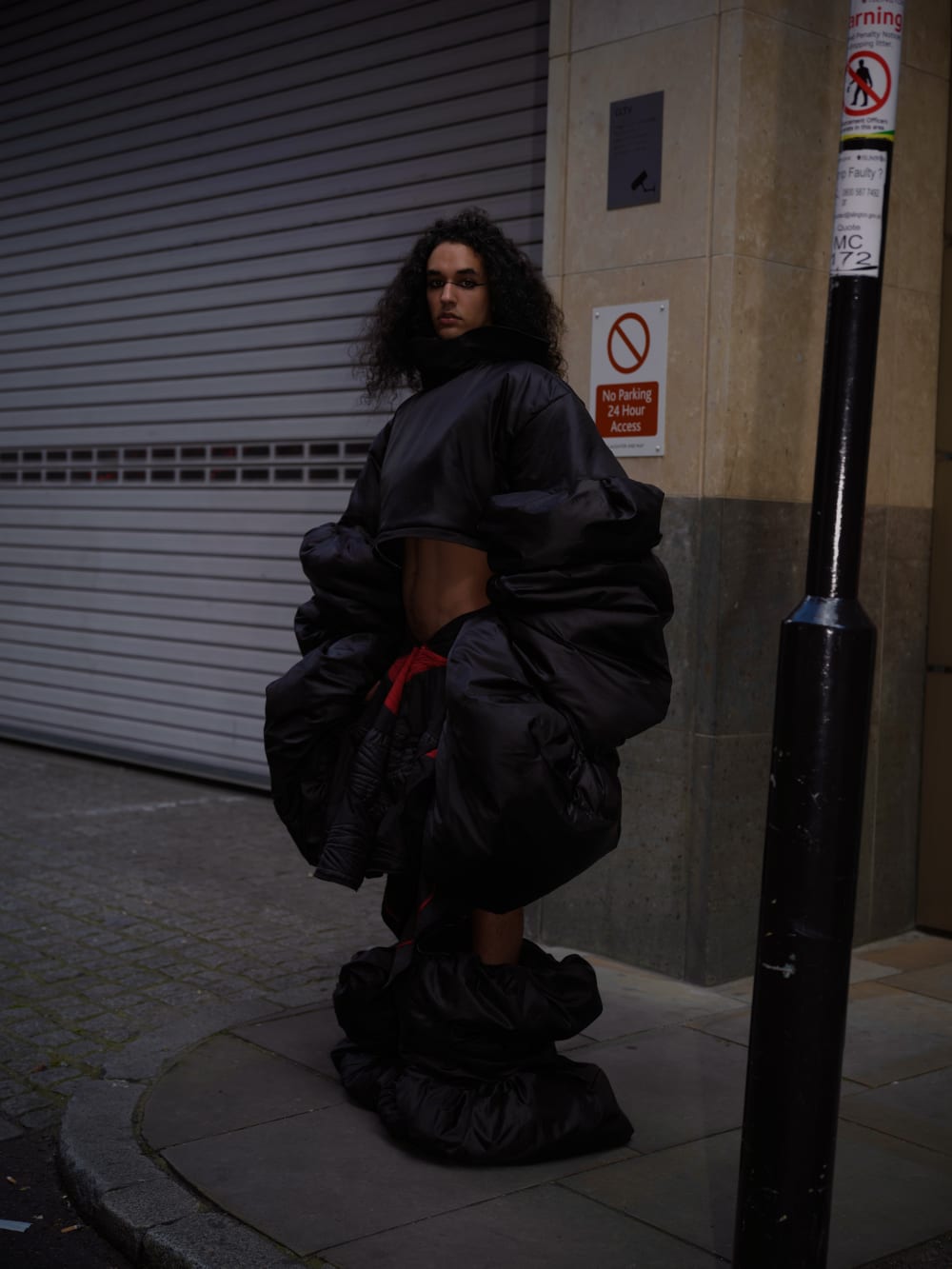 Model wearing black oversized puffy cropped top, shorts and shoes part of the JAIM collection