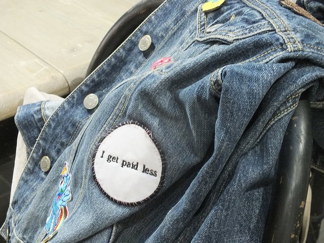 A jean jacket with a badge on it saying