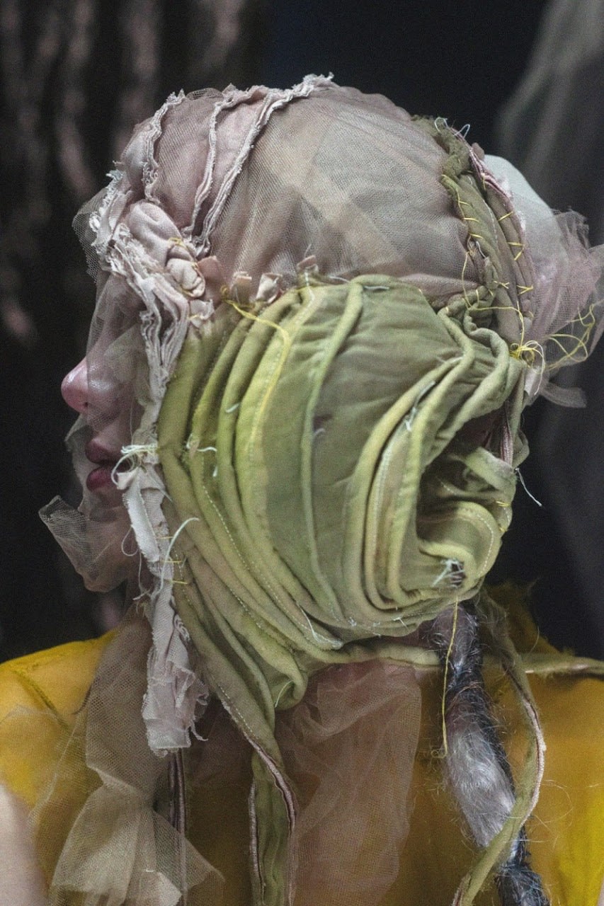 Head covered with green and transparent headpiece