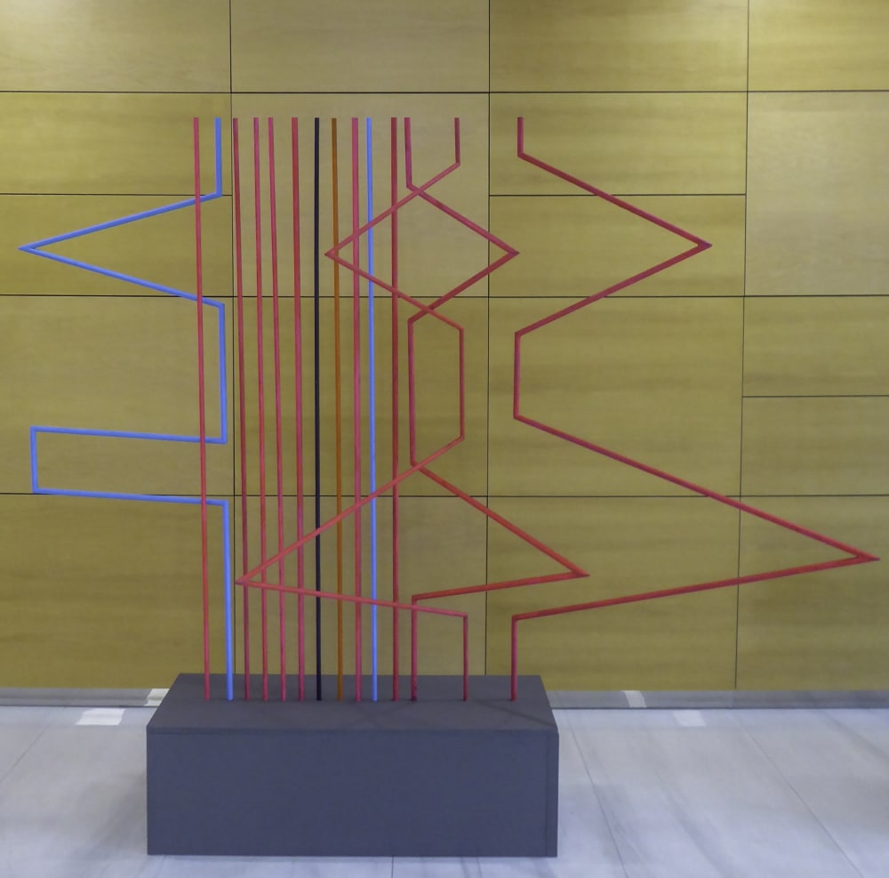 Photo of a sculpture against a yellow backdrop