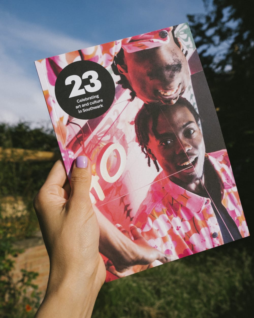 A hand holding a magazine