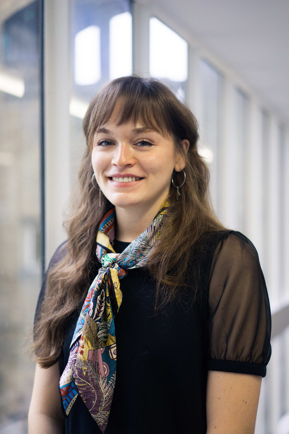 Female wearing scarf in front of the windows