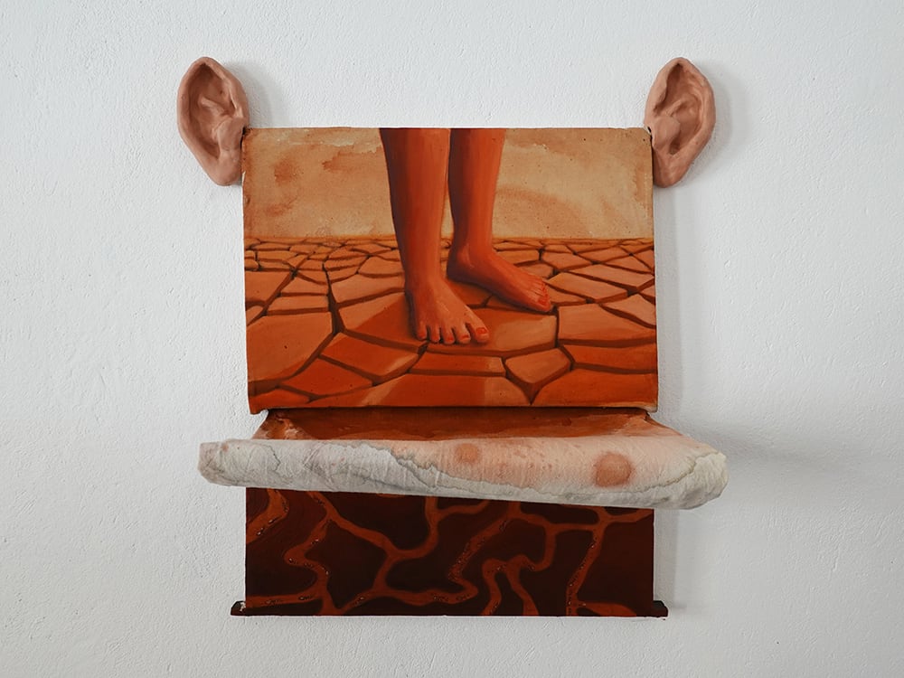 Painting of feet standing on cracked, dry earth. In oranges, browns and red paints