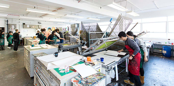 A large group of students at work in the Printmaking area.