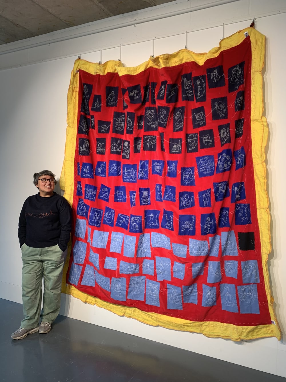 Photo of Tina standing next to Connected by a Thread