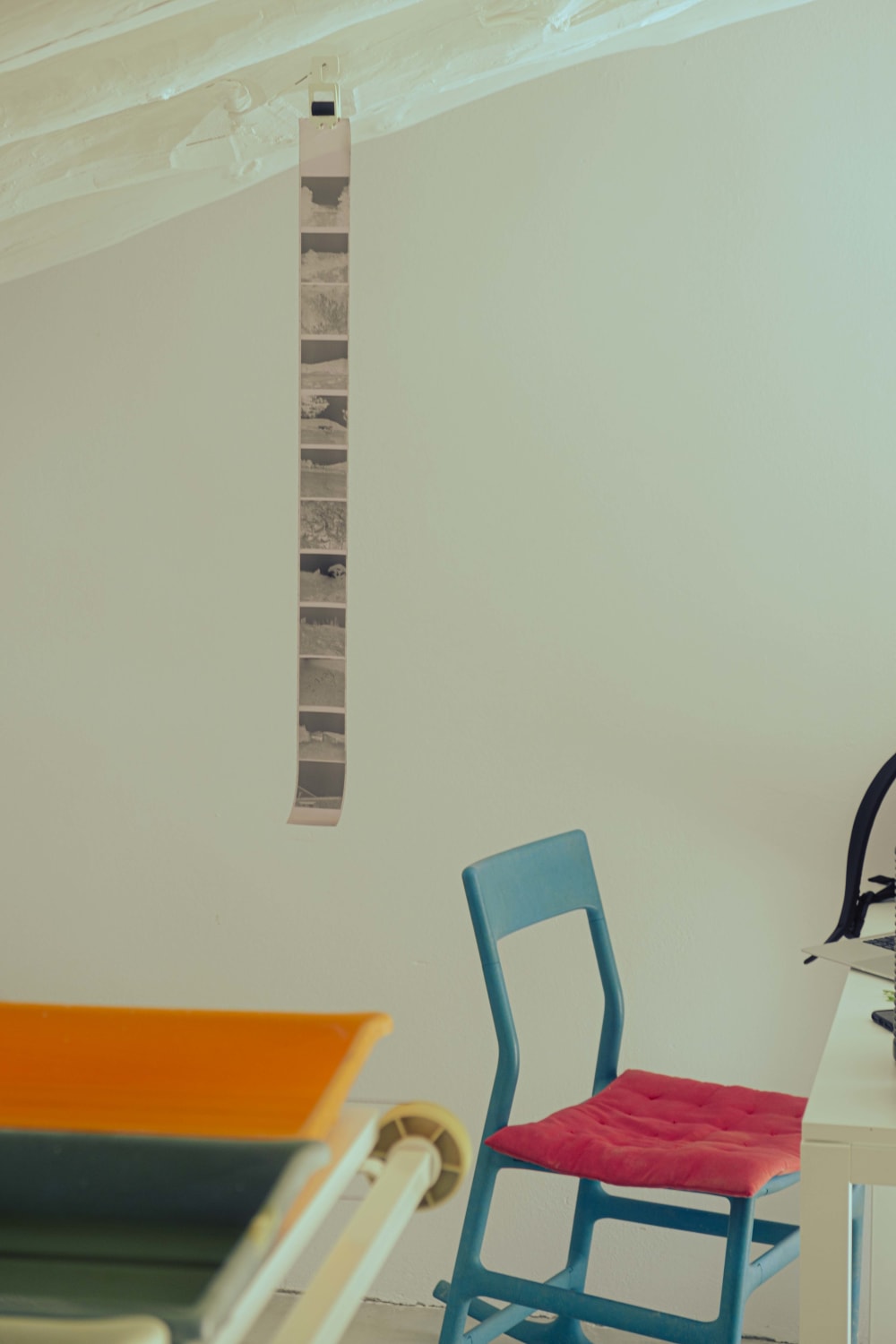 a studio with film negatives hanging on the wall