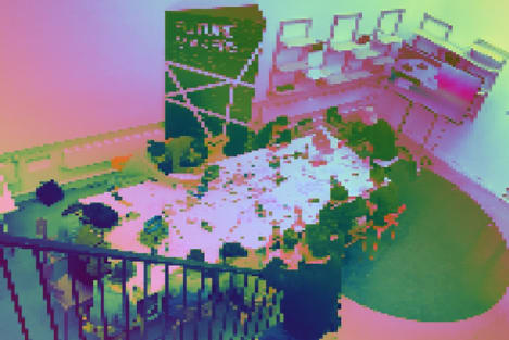 A glitch image of a man walking dow stairs, overlooking a group of students working around a desk.