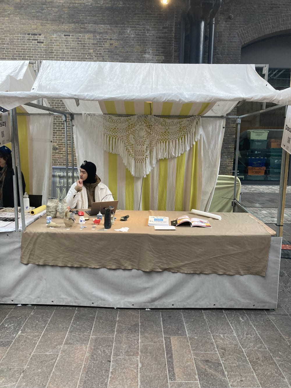 Stallholder showcasing artworks