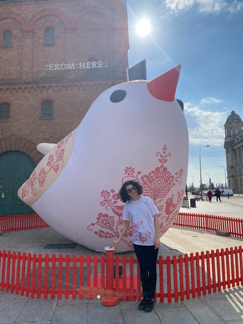 public art sculpture big bird with woman stood in front