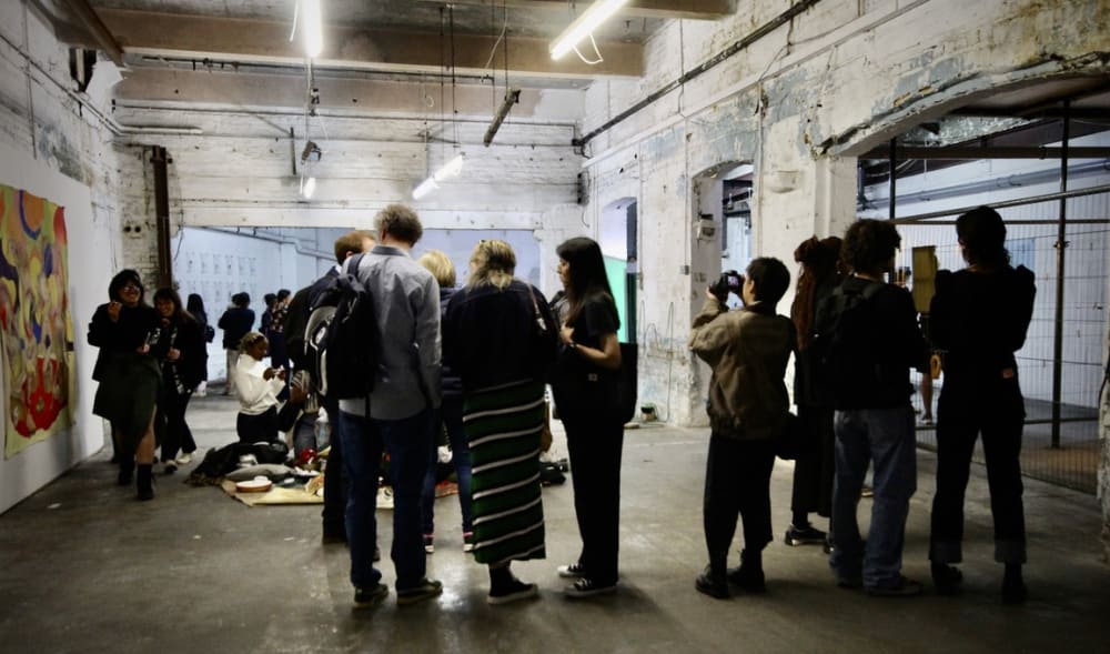 crowd of people in a gallery looking at works