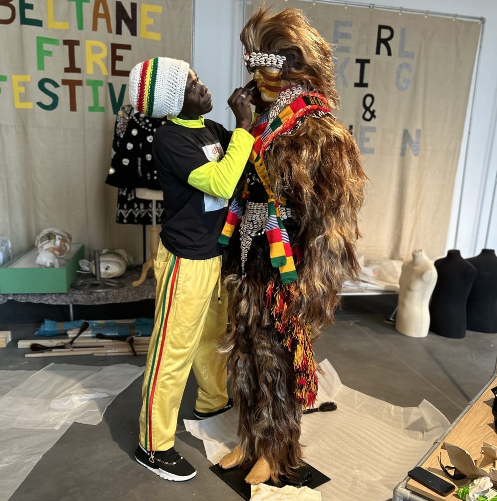 Mouliaye installing lion costume and painting face