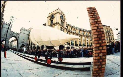 Paper cone on wheels next to a brick wall