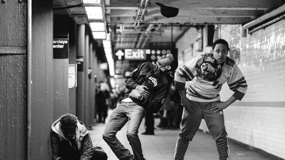3 male street dancers doing a performance on the subway