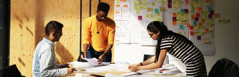Service Design students working around a desk.