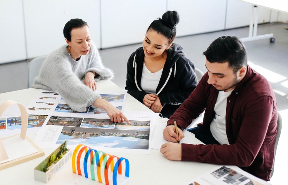 Students with tutor pointing at spatial designs