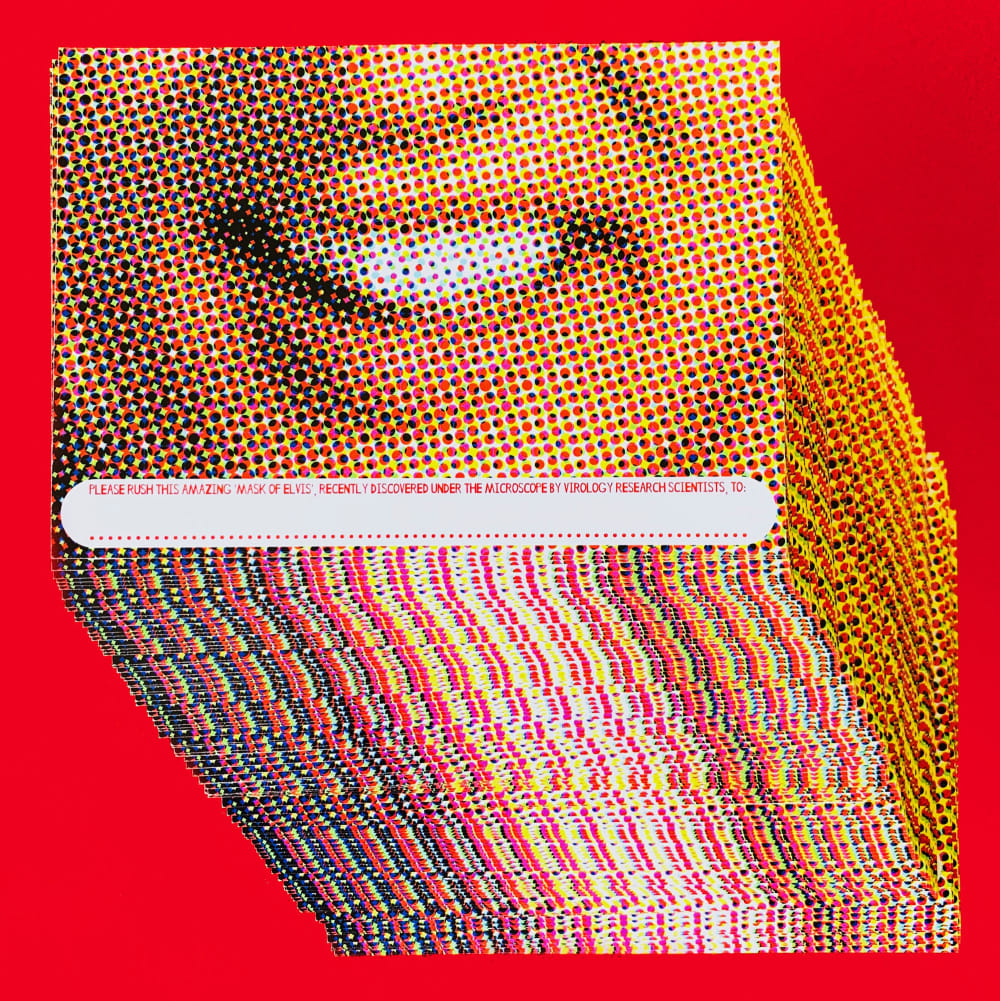 A stack of postcards with a close-up of the singer Elvis' smile