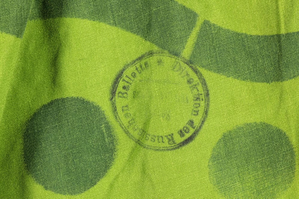 Green fabric with black ink stamp reading 'Direktion des Russischen Ballets'