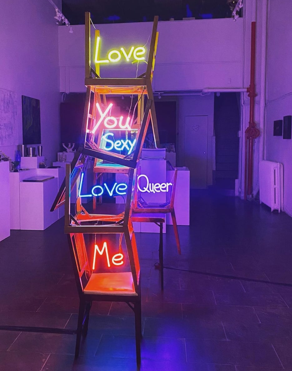 Photo of Carl's works 'Chair Therapy: You Changed my Life' and 'Love Each Other' in neon