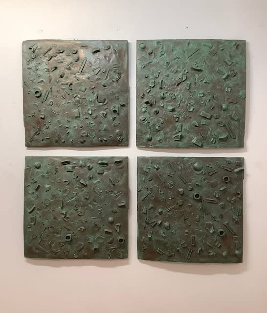 Four green squares on a wall