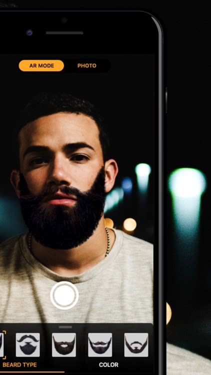 A phone camera held up to a man with a beard