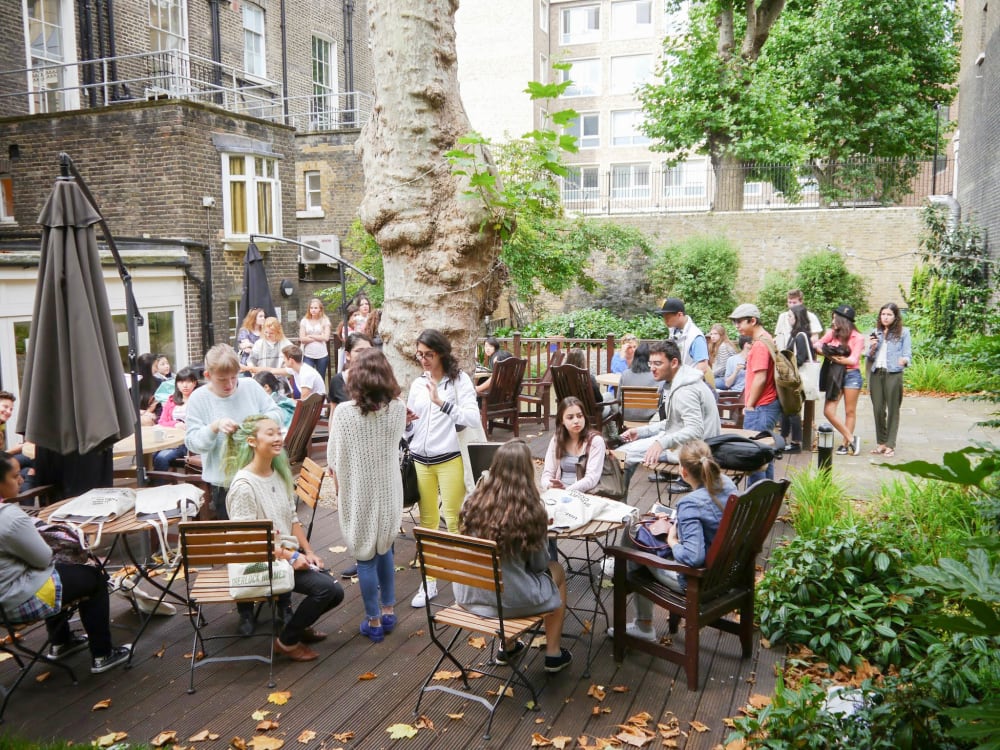 Summet Stay Social event in garden with students.