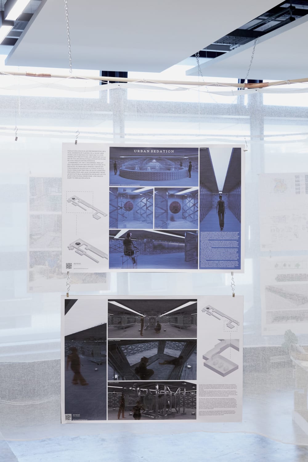 Image shows 2 pieces of white paper hanging down against a white backdrop. The pieces of paper contains what looks to be designs.