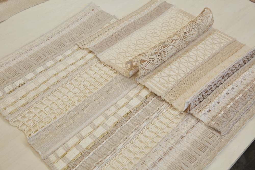Two woven fabric pieces are laid out on a table