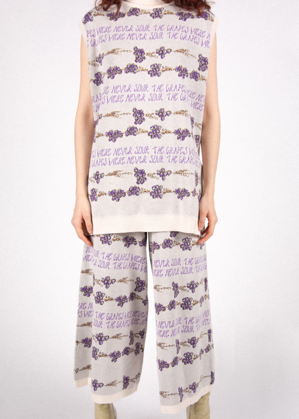 Person wearing floral knitwear designs