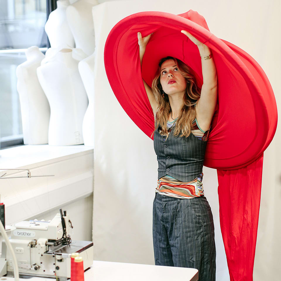 Student Flo Pawley places her costume above her head in the studio