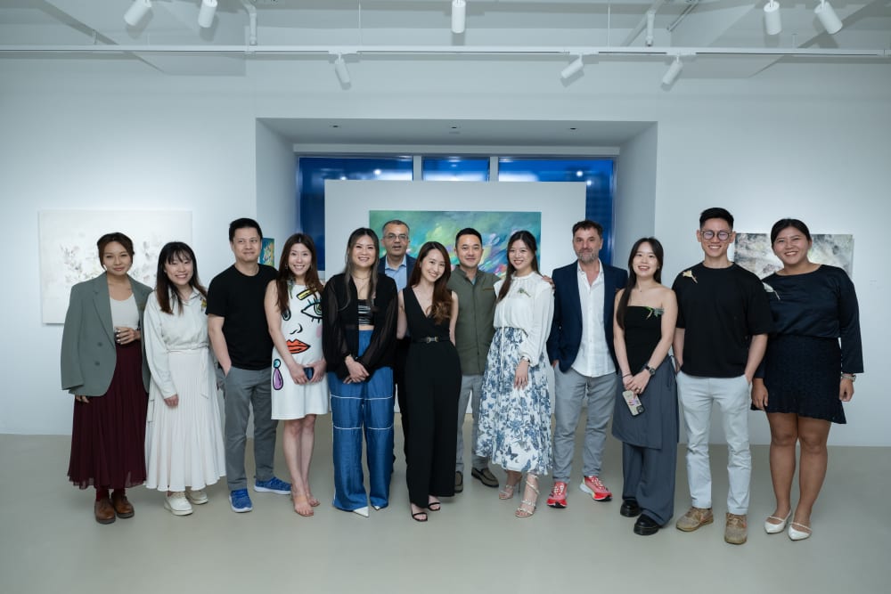 A group of people standing in 3812 gallery, smiling to the camera