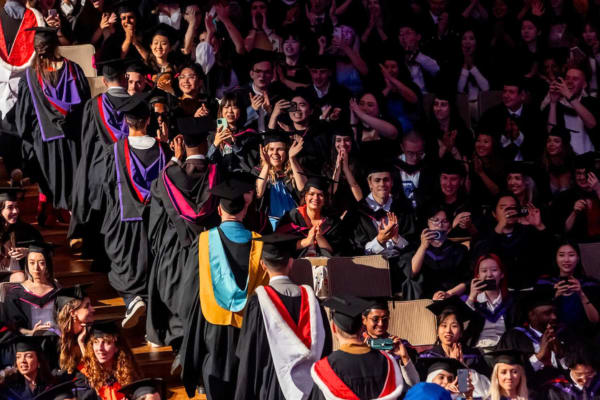 Birds eye shot of students at their graduation, wearing in their graduation gowns
